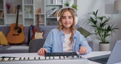 Teenager Playing Music Keyboard at Home