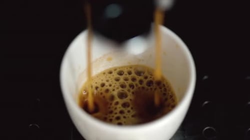 Espresso Pouring into White Cup in Close-Up