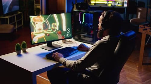 Gamer Playing Video Game on Desktop Computer