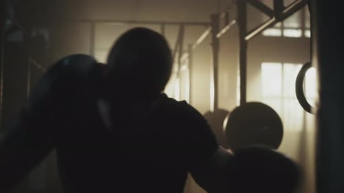Strong Man Boxing in a Dusty Gym