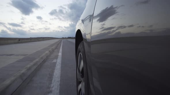A car driving slowly along the road before sunset, Vehicles Stock ...
