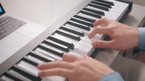 Young Adult Plays Digital Midi Keyboard