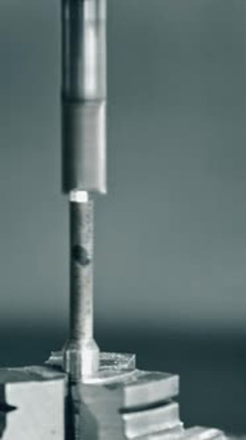 Metal drilling machine in action on workpiece in closeup view