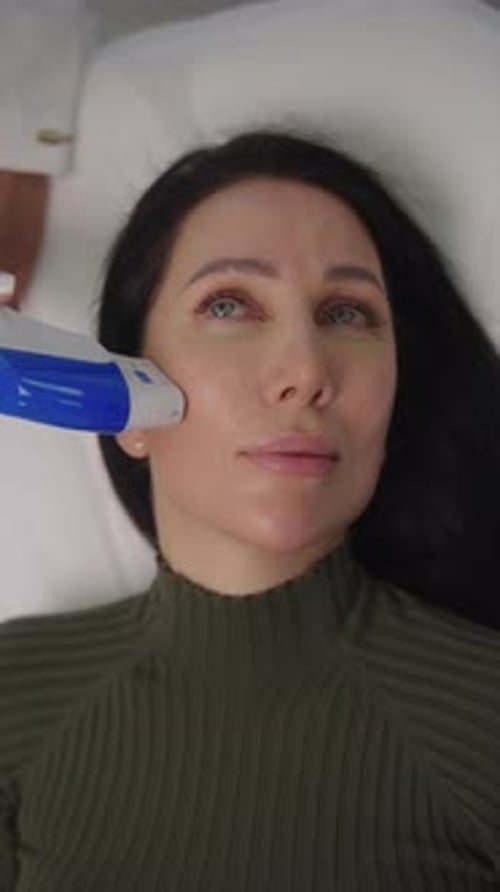 Woman Receives Facial Treatment in Medical Spa