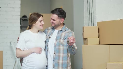 close up of the hands happy married couple holding keys to a new apartment. family bought a house