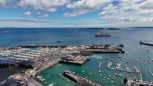 High drone flight St Peter Port harbour,ferry berth,docks and marinas Guernsey with views of cruise