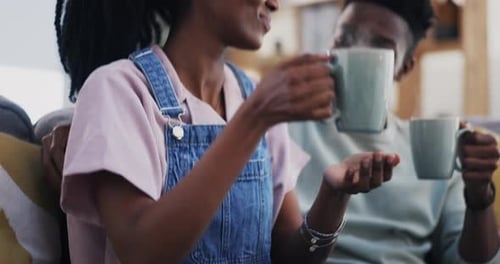 Happy Couple Drinking Coffee on Couch at Home