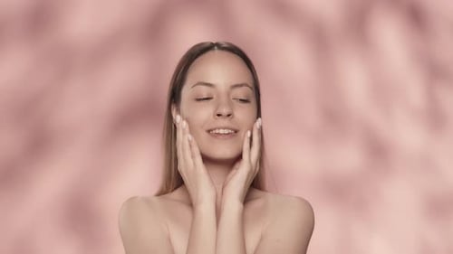 Young Woman Touching Her Face and Shoulders