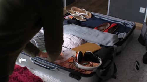 Packing Suitcase With Clothing and Accessories