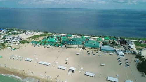Aerial Over the Sandy Beach with Many People and Azure Water on a Summer Day Waves Crashing to the