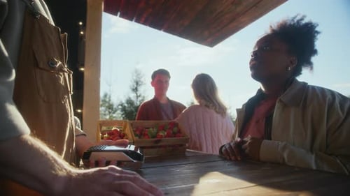 Black Woman Buying Fresh Strawberries at Outdoor Farm Market