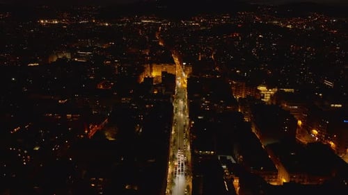 High Angle View of Well Illuminated Street in Urban Neighbourhood Vehicles Driving in Night