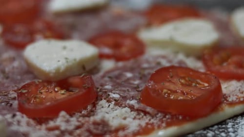 Uncooked Pizza Topped with Fresh Ingredients Close Up