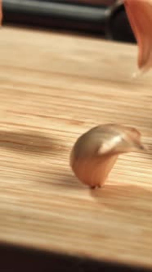Garlic Will Fall on a Wooden Table Filmed on a Highspeed Camera at 1000 Fps