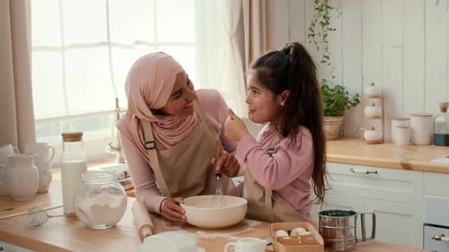 Mother and Daughter Baking Together in a Cozy Kitchen at Home