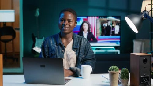 Portrait of Happy Woman Sitting at Home Office Desk in Front of Laptop