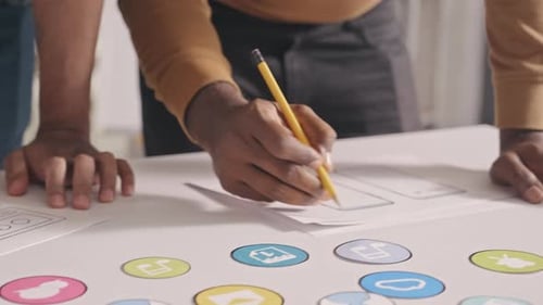UX Designers Working on Mobile App Interface