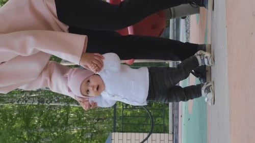 Baby Girl Learning to Walk with Mom