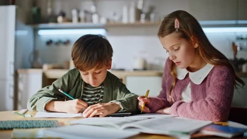 Clever Children Completing Homework Home Desk Closeup Brother Sister Writing
