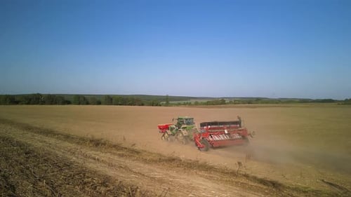 Tractor on the field seeding wheat