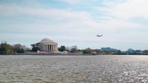 An airplane flying past the jefferson memorial