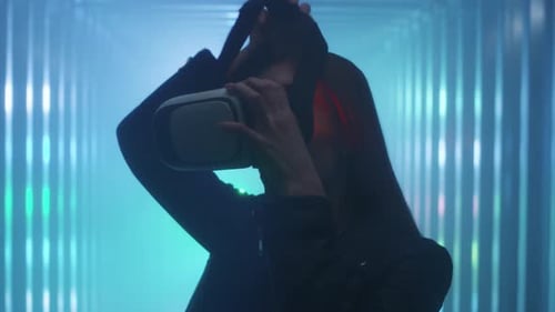 Woman puts on VR Headset in Futuristic Room