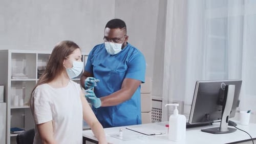 Doctor Giving Injection to Patient in Clinic