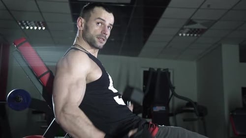 Brutal Man Shakes His Biceps in the Gym