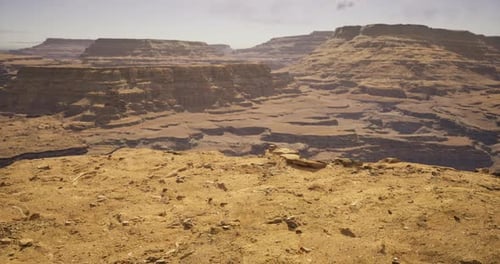 Expansive Sandstone Cliffs Stretch Across a Vast Desert Landscape in Daylight