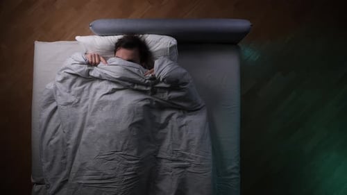 Man Lying in Bed Covering Himself With Blanket