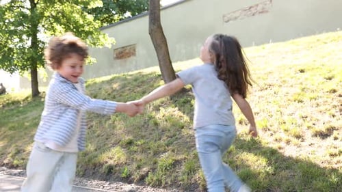 Cute little kids having fun together in park