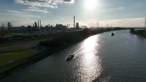 Zoom out aerial view of Antwerp industrial canal and factories