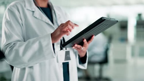 Doctor Using Tablet in Medical Environment