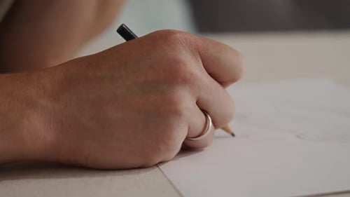 Hand Drawing with Pencil on White Paper