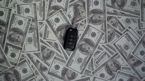 Car keys with dollars. Automobile cost concept.