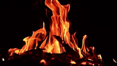 Night fireplace glowing. Bonfire flame heating in slow motion.