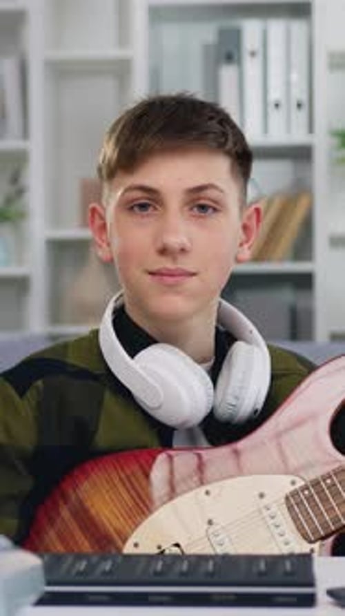 Portrait Smiling Boy Looking at Camera European Male Learning an Electro Guitar in Home Studio with