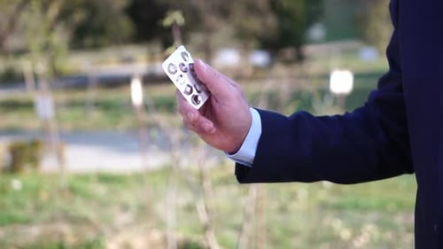 Man Throws Pills or Tablets in Waste