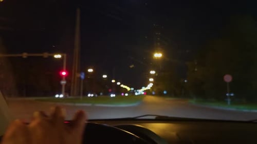 A Captivating View of a City Street at Night Captured From the Perspective of a Vehicle Driving By