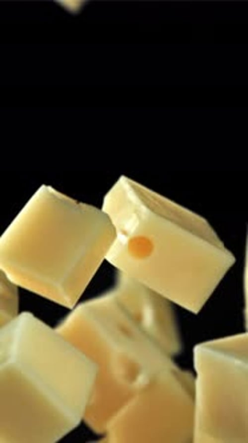 Super Slow Motion Pieces of Cheese on Black Background Filmed on a Highspeed Camera at 1000 Fps