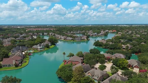 Aerial View of Suburban Homes and Lake on Sunny Day