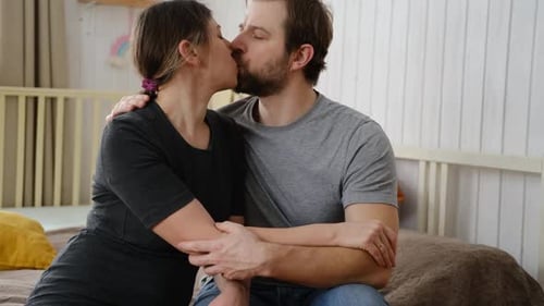 Loving Couple Embrace on Bed at Home