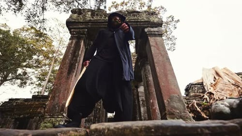 Person in Mask Walks With Sword