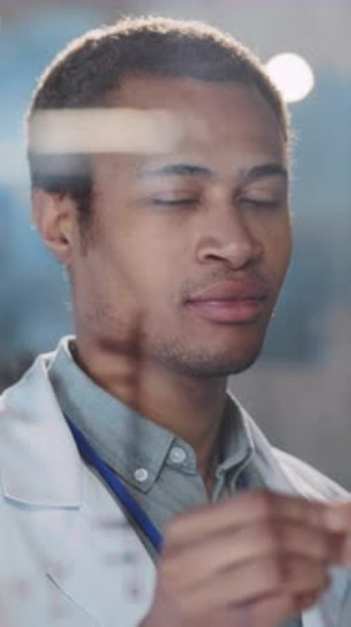 Young Adult Lab Worker Portrait Behind Glass