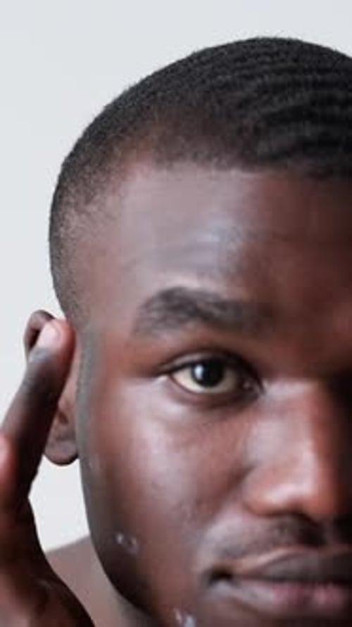 Man Applies Cream for Skincare Routine