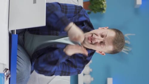 Vertical video of Home office worker man gives motivational speech.
