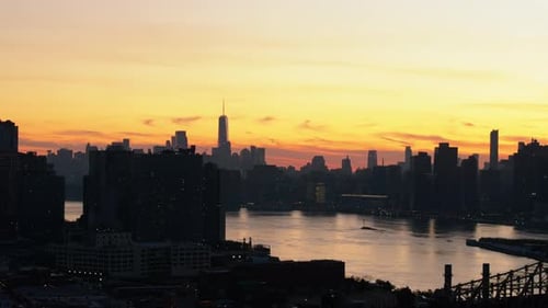 Sunset Over the East River with Lower East Side Skyline Background and Queensboro Bridge Connecting