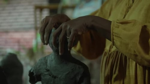 Woman Creating Clay Sculpture in Studio