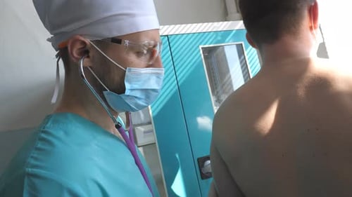 Doctor Examines Patient with Stethoscope in Hospital
