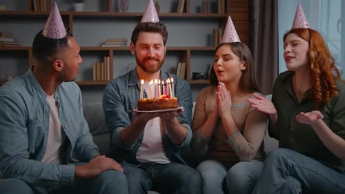 Friends Celebrate Birthday with Cake and Party Hats